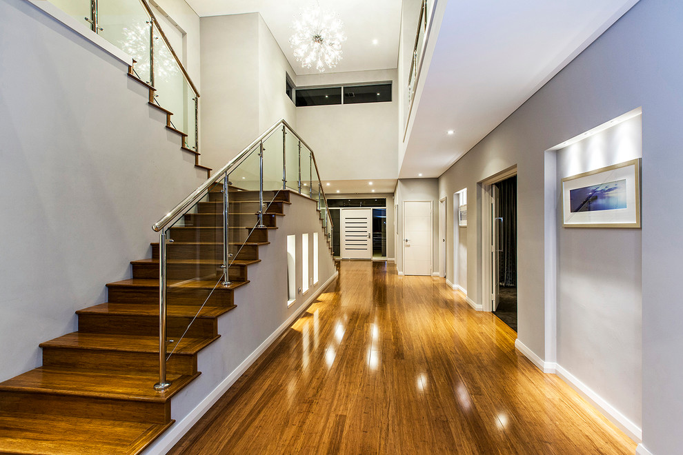 Photo of an expansive contemporary hallway in Perth with grey walls and medium hardwood floors.