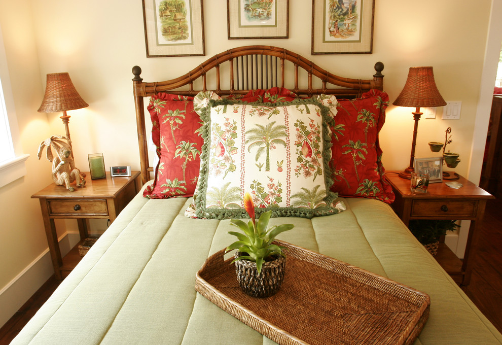 Design ideas for a tropical bedroom in Los Angeles with beige walls and medium hardwood floors.