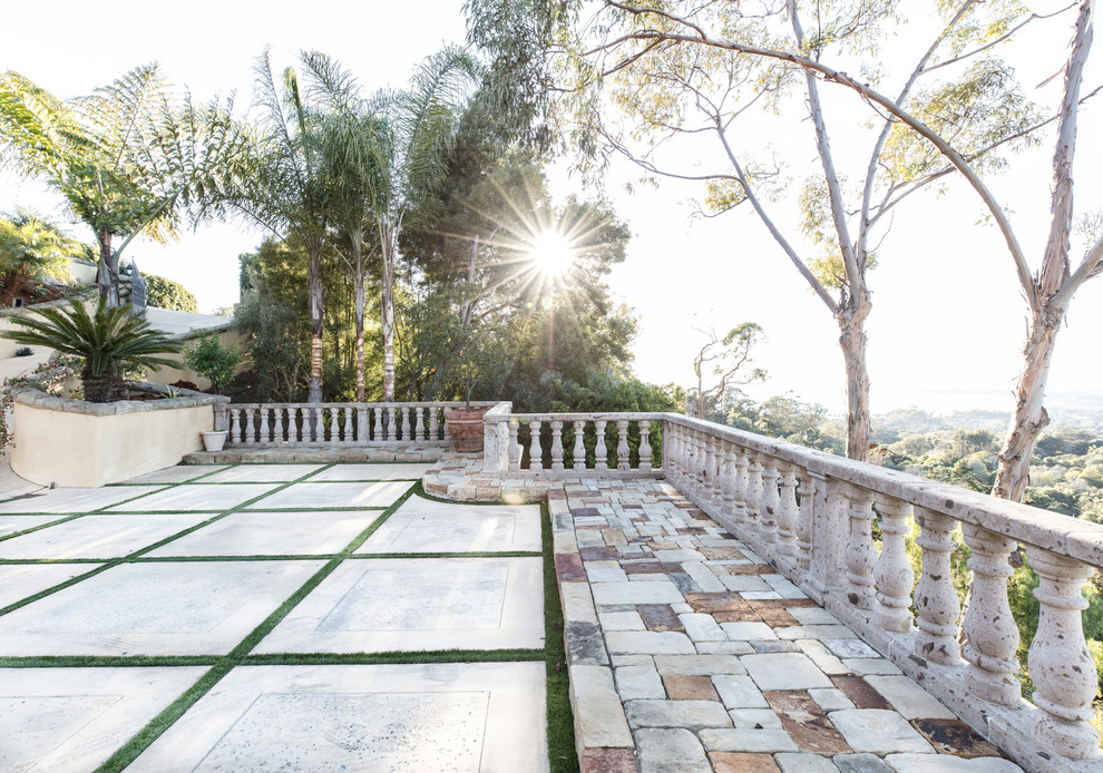 Inspiration for a mediterranean backyard patio in Santa Barbara with natural stone pavers.