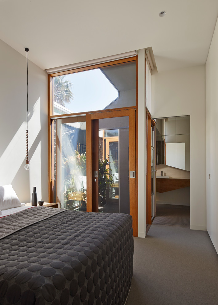 Photo of a mid-sized contemporary master bedroom in Melbourne with white walls and carpet.