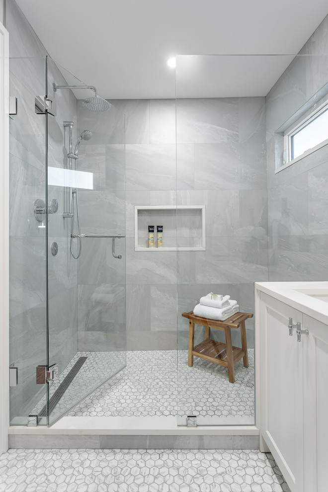 This is an example of a small traditional master wet room bathroom in Vancouver with blue cabinets, a one-piece toilet, gray tile, porcelain tile, grey walls, porcelain floors, an undermount sink, engineered quartz benchtops, white floor, a hinged shower door, white benchtops and recessed-panel cabinets.