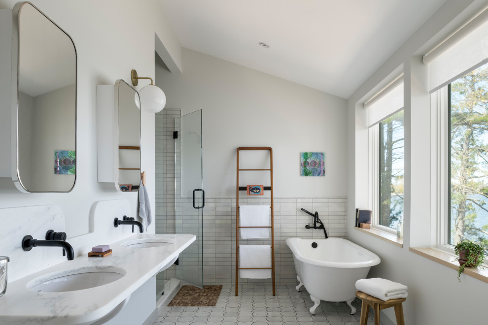 Mid-sized contemporary master bathroom in New York with white cabinets, a claw-foot tub, a two-piece toilet, white tile, terra-cotta tile, white walls, terra-cotta floors, an undermount sink, marble benchtops, white floor, a hinged shower door, white benchtops, a double vanity, a floating vanity and vaulted.