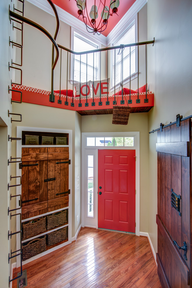 Inspiration for a small transitional gender-neutral dark wood floor single front door remodel in DC Metro with beige walls and a red front door