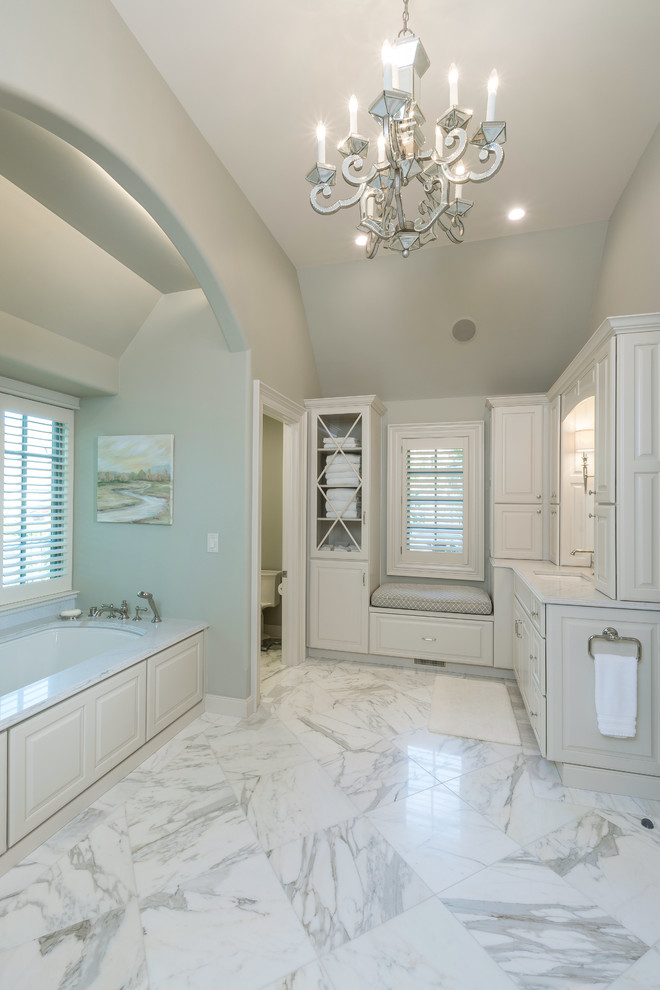 Design ideas for a large traditional master bathroom in Columbus with raised-panel cabinets, white cabinets, an undermount tub, an alcove shower, a two-piece toilet, green tile, green walls, marble floors, an undermount sink, marble benchtops and a hinged shower door.
