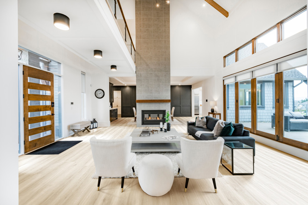 Example of a minimalist open concept vinyl floor, beige floor and vaulted ceiling living room design in Los Angeles with white walls, a ribbon fireplace, a tile fireplace and no tv