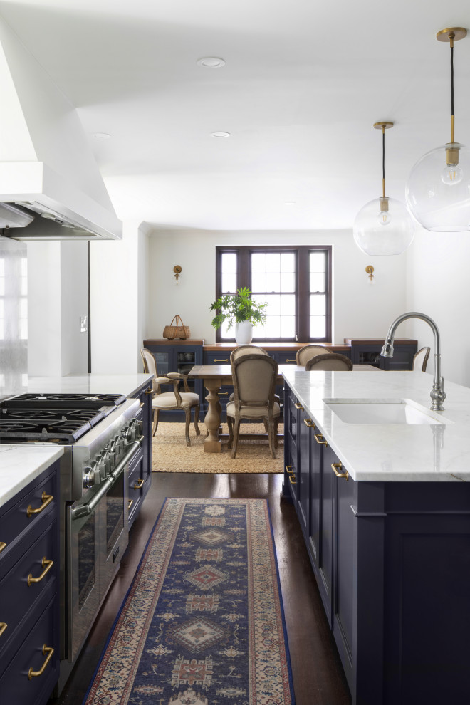 Example of a large classic dark wood floor and brown floor eat-in kitchen design in Milwaukee with an undermount sink, shaker cabinets, blue cabinets, quartzite countertops, white backsplash, stone slab backsplash, paneled appliances, an island and white countertops