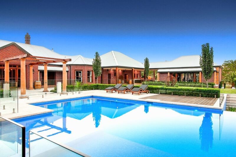Photo of an expansive contemporary backyard rectangular lap pool in Sydney with a water feature and decking.