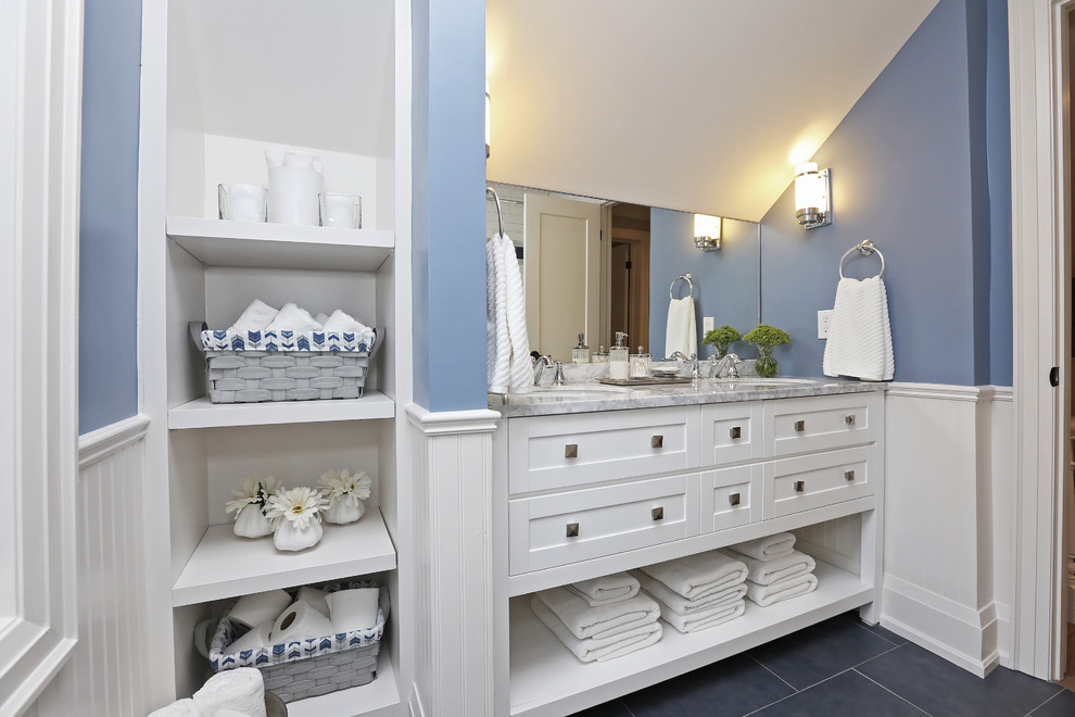 Inspiration for a mid-sized transitional kids bathroom in Toronto with shaker cabinets, white cabinets, an alcove tub, a shower/bathtub combo, white tile, porcelain tile, blue walls, porcelain floors, an undermount sink, blue floor, a shower curtain, grey benchtops and marble benchtops.
