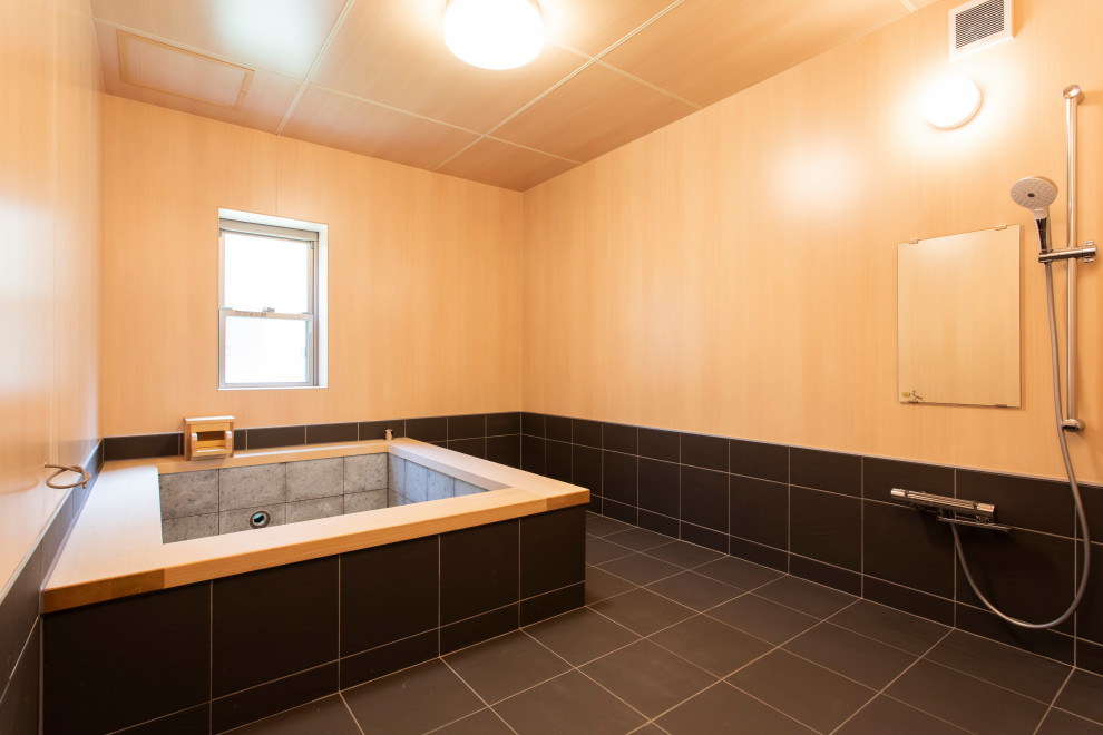 Idée de décoration pour une salle de bain avec un bain japonais et un mur beige.