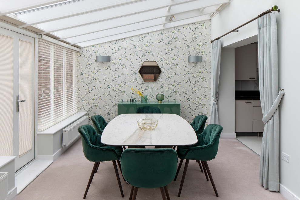 Mid-sized scandinavian open plan dining in Kent with green walls, carpet, no fireplace and beige floor.