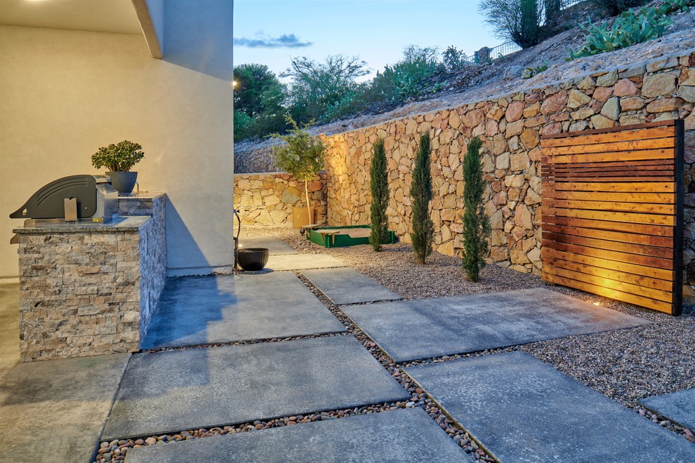 This is an example of a small drought-tolerant backyard concrete paver garden path.