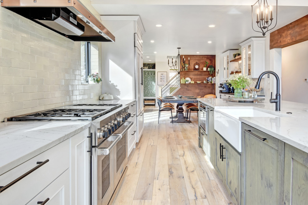 Mountain style kitchen photo in Denver with a farmhouse sink and stainless steel appliances