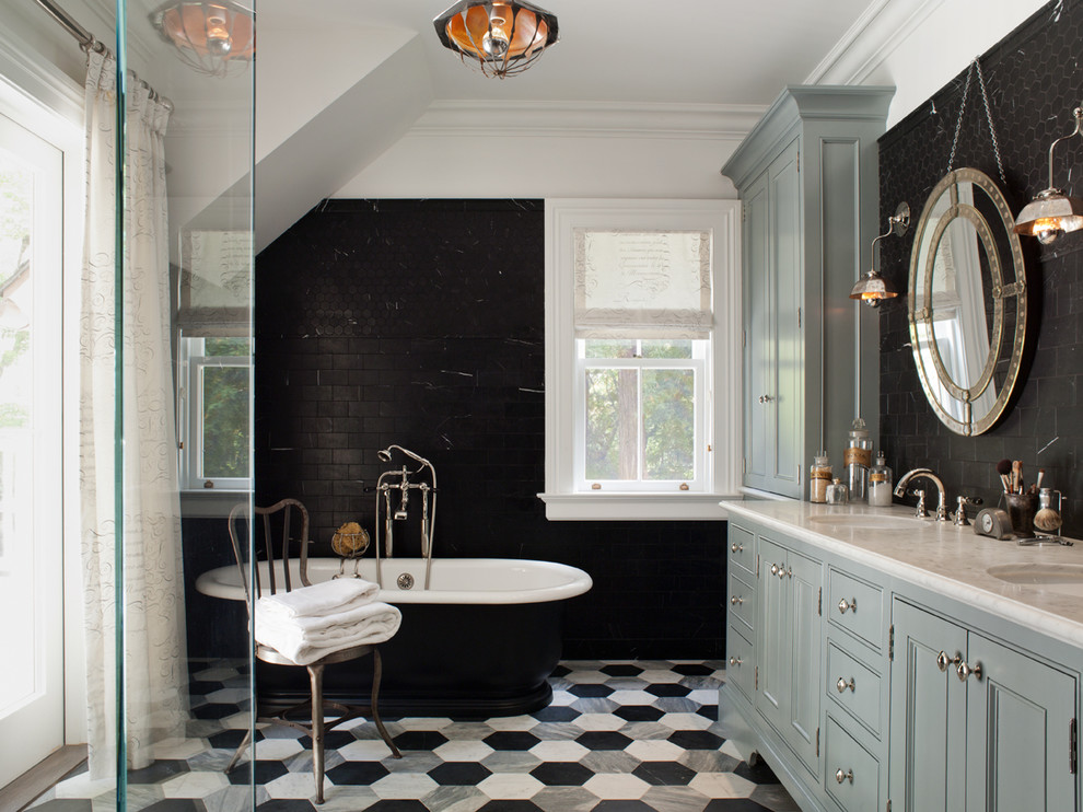 This is an example of a traditional bathroom in San Francisco with an undermount sink, beaded inset cabinets, grey cabinets, a freestanding tub, black tile and stone tile.