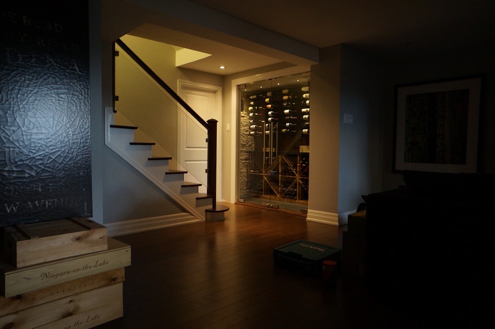 Mid-sized contemporary wine cellar in Toronto with ceramic floors, storage racks and grey floor.
