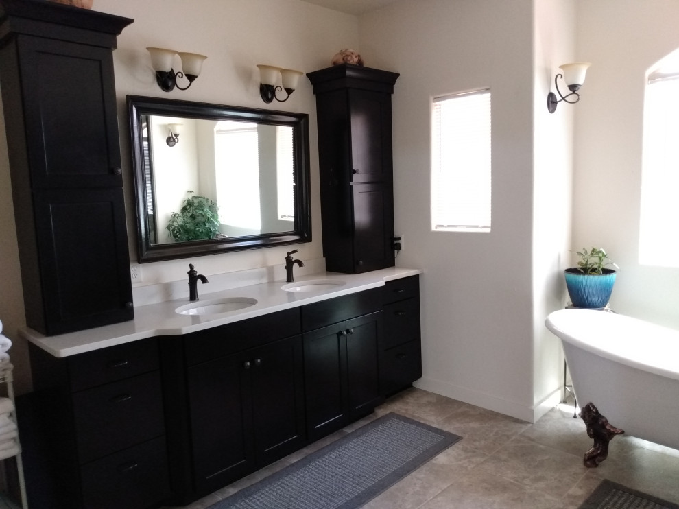 This is an example of a large mediterranean master bathroom in Salt Lake City with shaker cabinets, dark wood cabinets, a claw-foot tub, a double shower, mirror tile, ceramic floors, an undermount sink, engineered quartz benchtops, a hinged shower door, white benchtops, a shower seat, a double vanity and a built-in vanity.