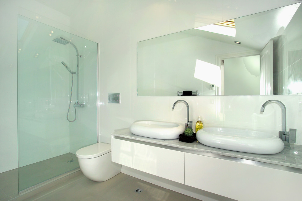 Expansive contemporary bathroom in Auckland with a vessel sink, flat-panel cabinets, white cabinets and dark hardwood floors.