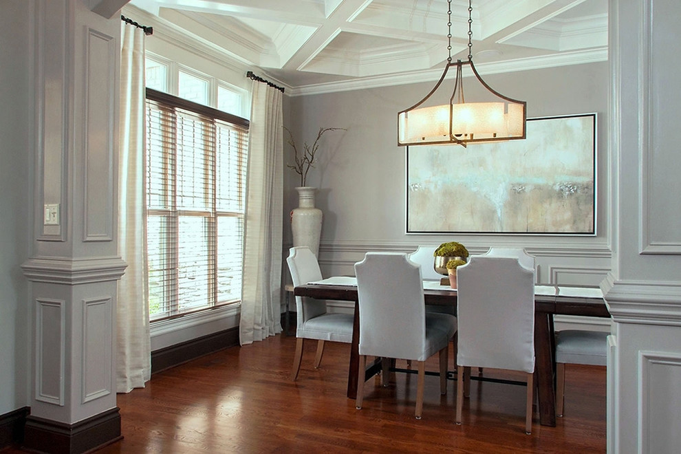 This is an example of a large traditional dining room in Other with grey walls, dark hardwood floors and brown floor.