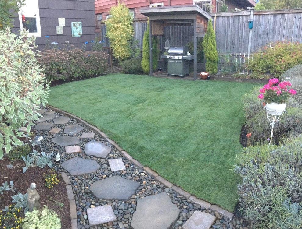Photo of a full sun backyard stone formal garden in Seattle for spring.