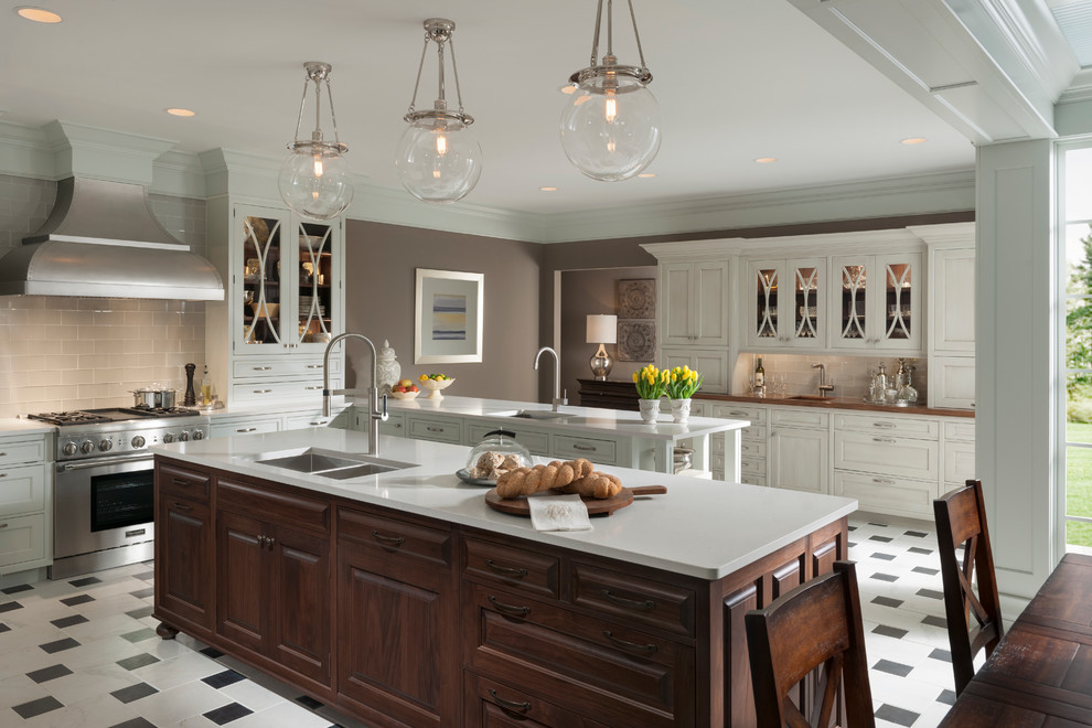 Inspiration for a large traditional u-shaped eat-in kitchen in Houston with a double-bowl sink, white cabinets, glass benchtops, grey splashback, subway tile splashback, stainless steel appliances, ceramic floors and multiple islands.
