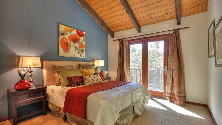 Photo of a mid-sized country master bedroom in San Francisco with blue walls, carpet, no fireplace and beige floor.