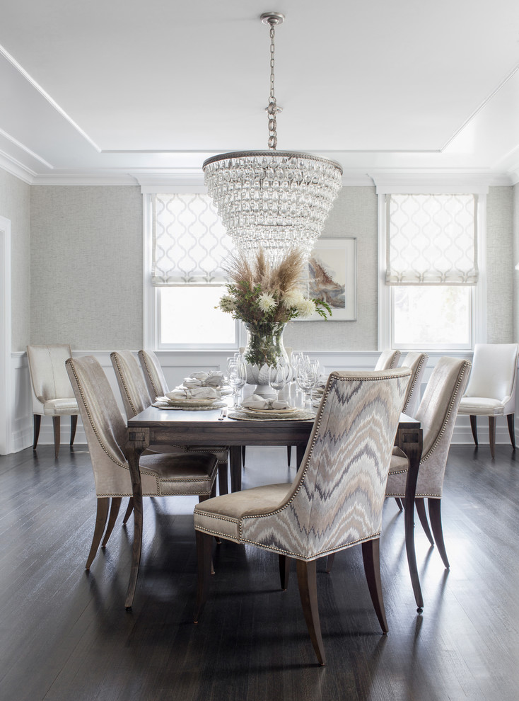 Photo of a beach style dining room in New York with grey walls and dark hardwood floors.