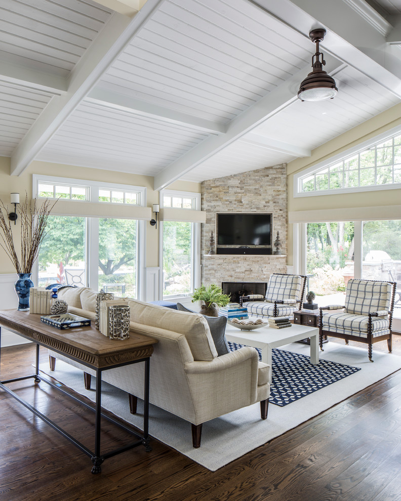 Example of a large transitional open concept dark wood floor family room design in New York with beige walls, a corner fireplace and a wall-mounted tv