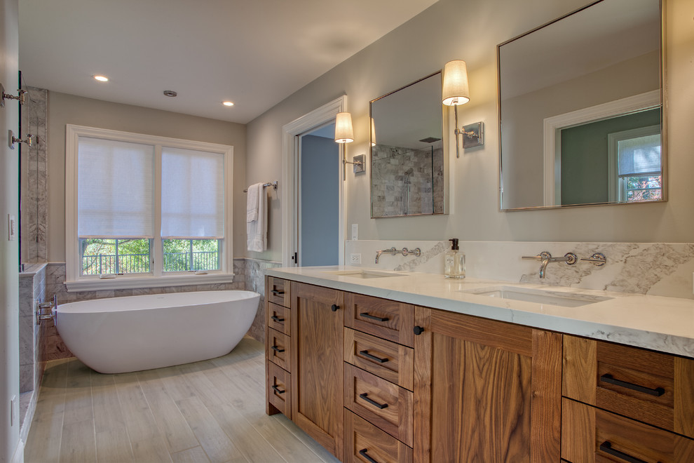 This is an example of a transitional master bathroom in San Francisco with shaker cabinets and medium wood cabinets.