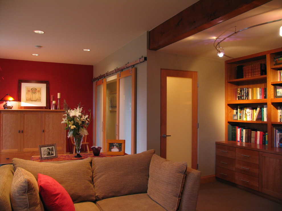 This is an example of a large contemporary enclosed family room in Seattle with beige walls, carpet and no fireplace.
