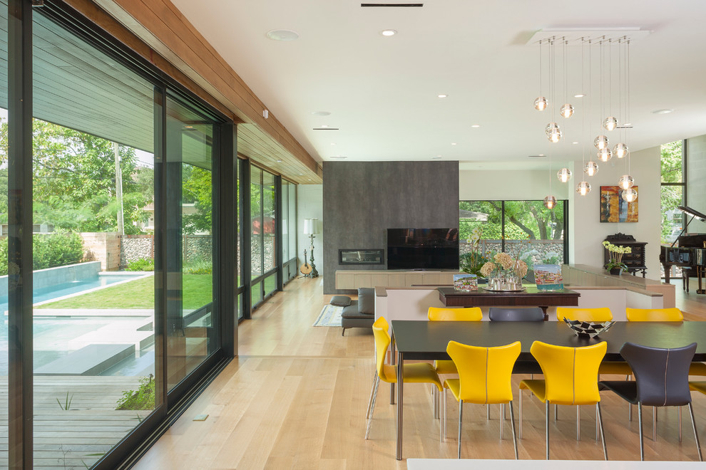 Contemporary kitchen/dining combo in Houston with light hardwood floors.