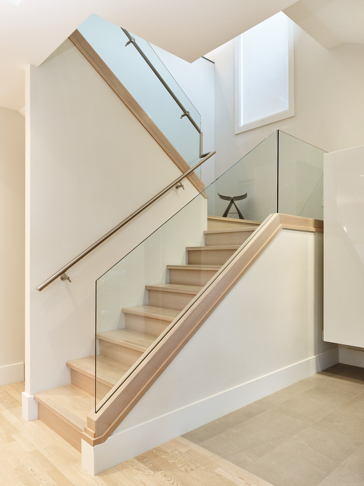 This is an example of a contemporary wood u-shaped staircase in Vancouver with wood risers.