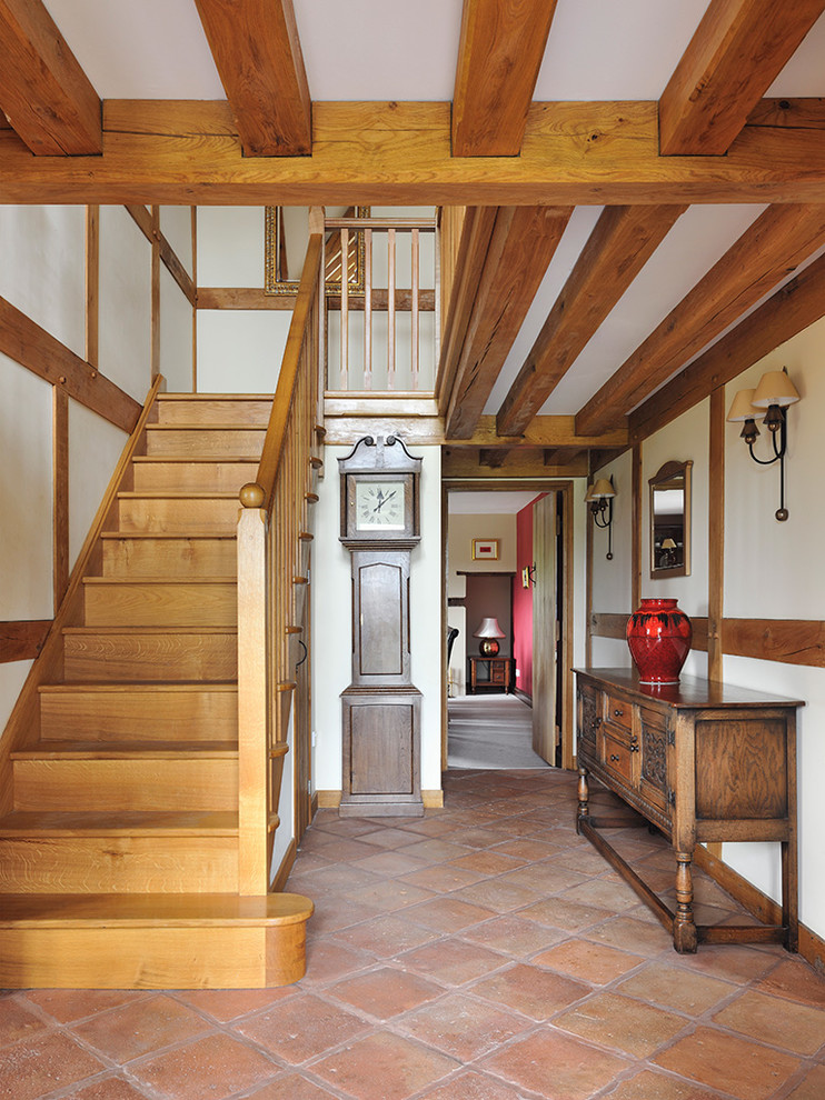 This is an example of a country foyer in Other with white walls.