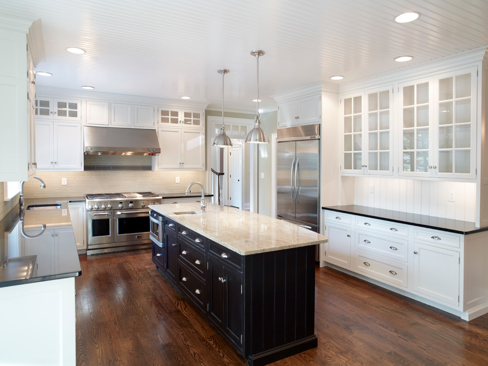 Design ideas for an expansive transitional u-shaped eat-in kitchen in Philadelphia with an undermount sink, white cabinets, laminate benchtops, white splashback, stainless steel appliances, medium hardwood floors and with island.