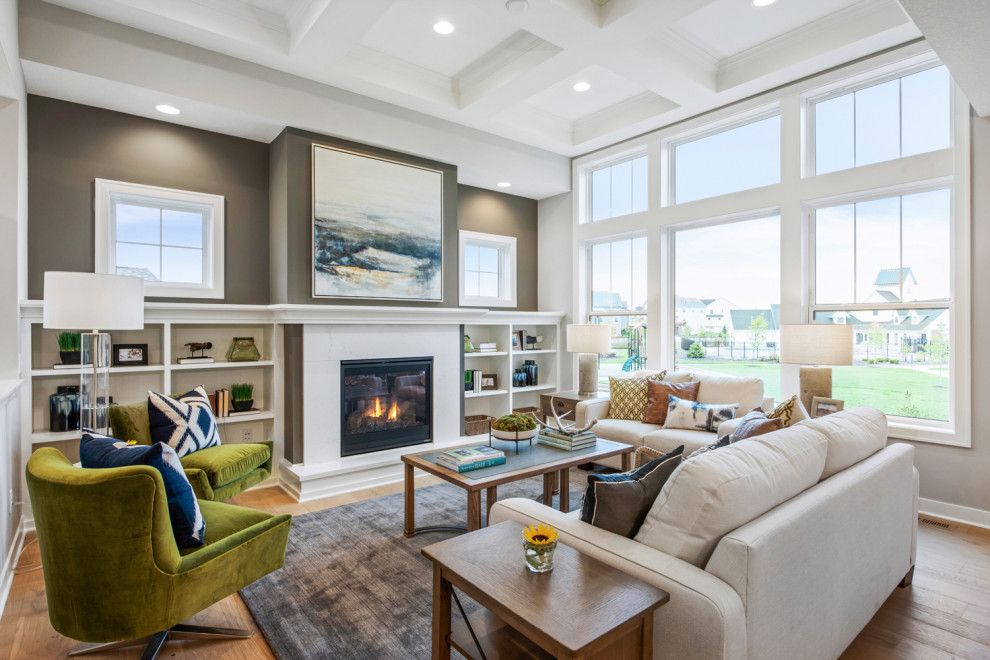 Photo of a transitional formal open concept living room in Minneapolis with grey walls, light hardwood floors, a standard fireplace, a stone fireplace surround, no tv and brown floor.
