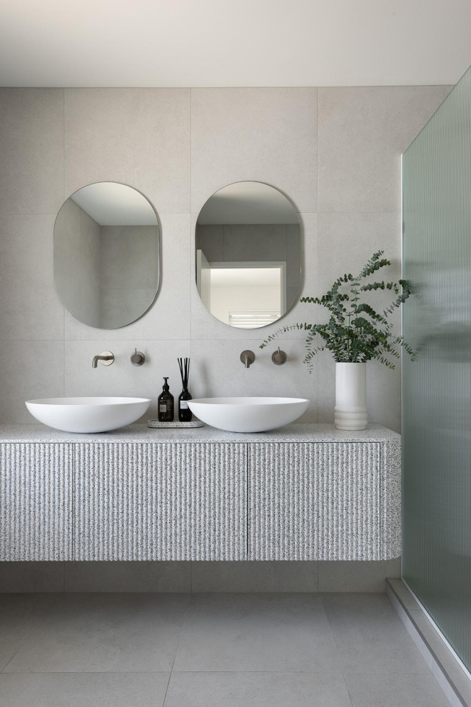Photo of a large modern master bathroom in Perth with furniture-like cabinets, grey cabinets, an open shower, gray tile, porcelain tile, grey walls, porcelain floors, a vessel sink, marble benchtops, grey floor, an open shower, grey benchtops, a shower seat, a double vanity and a floating vanity.