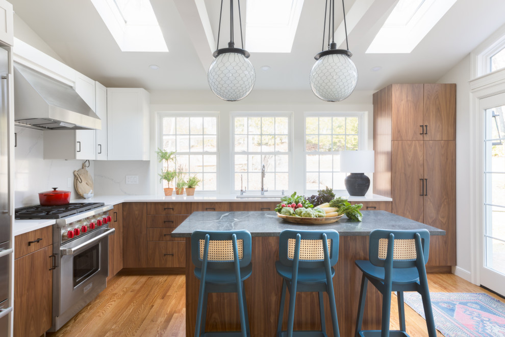 Kitchen - contemporary l-shaped medium tone wood floor and brown floor kitchen idea in Boston with an undermount sink, flat-panel cabinets, medium tone wood cabinets, white backsplash, stainless steel appliances, an island and gray countertops