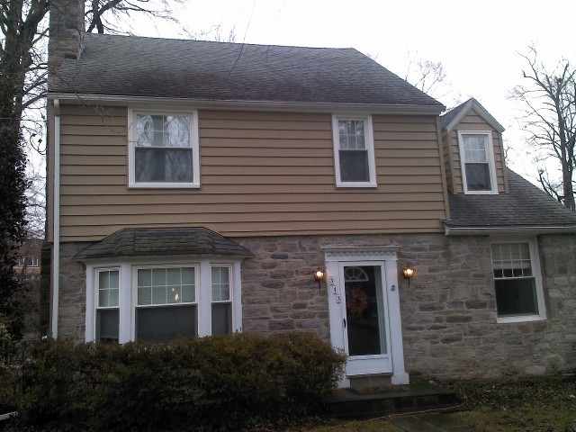Example of a mid-sized beige two-story mixed siding exterior home design in Philadelphia with a gambrel roof