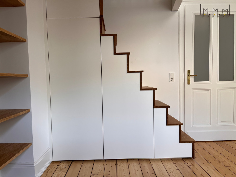 Staircase - large modern wooden straight wood railing and wallpaper staircase idea in Cologne with wooden risers