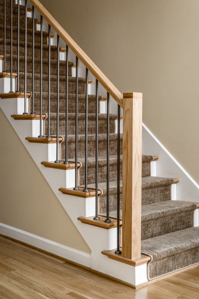 Foto de escalera recta minimalista de tamaño medio con barandilla de metal, escalones enmoquetados y contrahuellas enmoquetadas