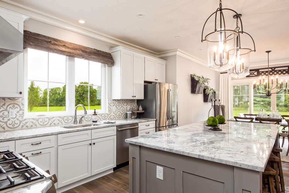 Inspiration for a traditional l-shaped eat-in kitchen in Columbus with granite benchtops, terra-cotta splashback, stainless steel appliances and with island.
