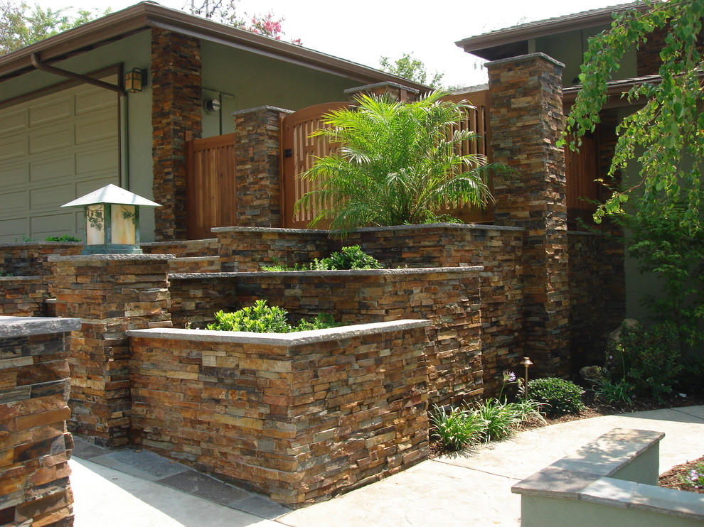 Design ideas for a large asian front yard full sun garden in Los Angeles with a retaining wall and concrete pavers.