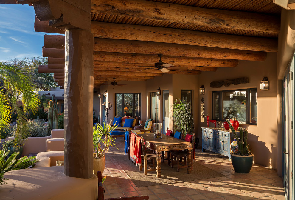 Photo of a patio in Phoenix with tile and a roof extension.