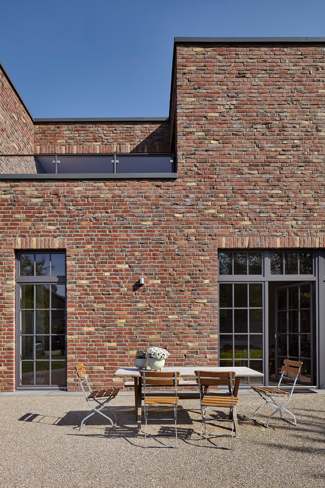 Industrial brick brown house exterior in Cologne with a flat roof.
