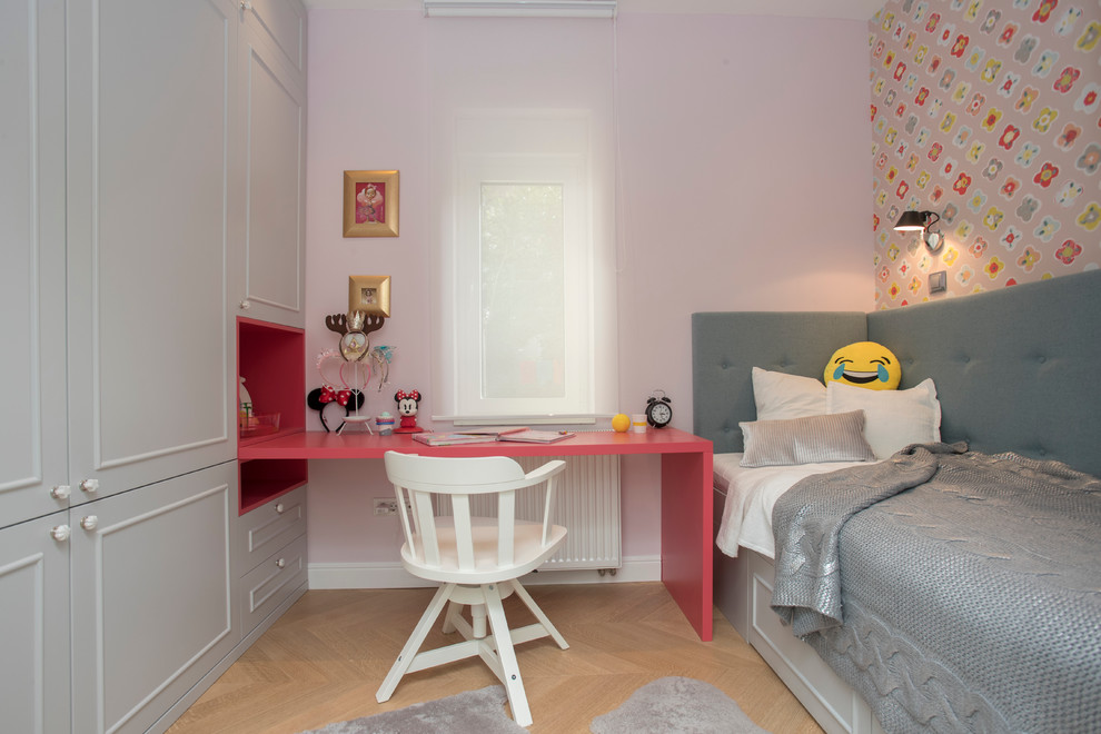 Small eclectic kids' bedroom in Other with pink walls and light hardwood floors for kids 4-10 years old and girls.