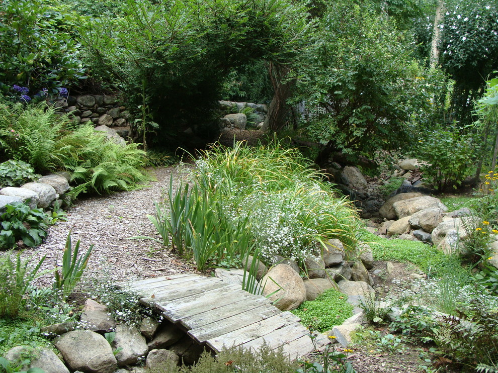 Photo of a large traditional backyard partial sun formal garden in New York with with pond and natural stone pavers.