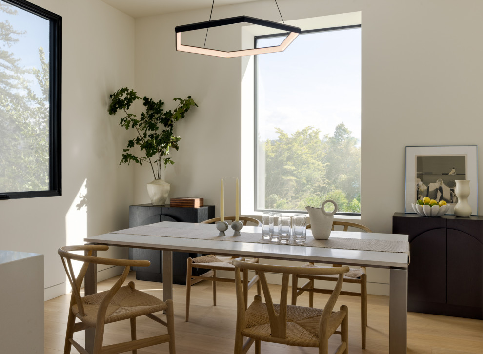 Minimalist light wood floor and beige floor dining room photo in San Francisco with white walls