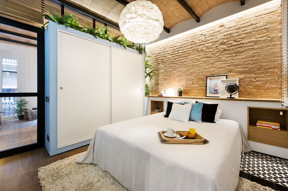Photo of a mid-sized beach style master bedroom in Barcelona with multi-coloured walls.