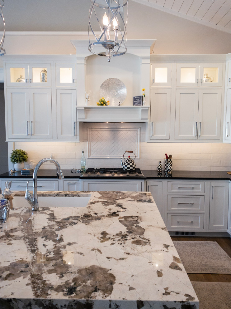 Inspiration for a large transitional l-shaped medium tone wood floor, gray floor and shiplap ceiling eat-in kitchen remodel with an undermount sink, flat-panel cabinets, white cabinets, granite countertops, yellow backsplash, subway tile backsplash, stainless steel appliances, an island and white countertops