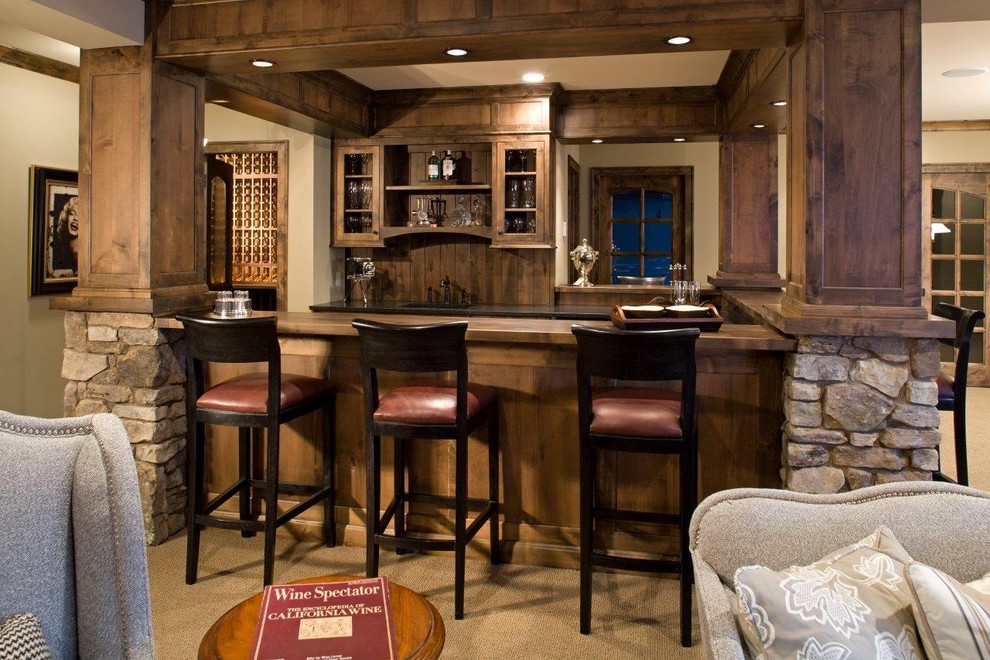 Photo of a country u-shaped seated home bar in Minneapolis with carpet, an undermount sink, glass-front cabinets and dark wood cabinets.
