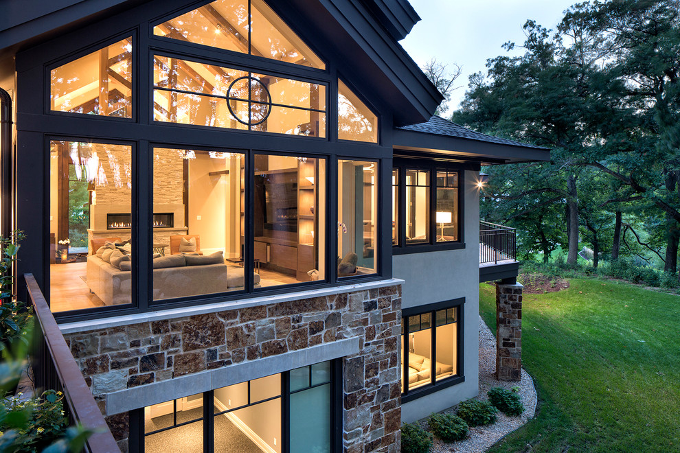Design ideas for an expansive contemporary three-storey beige exterior in Minneapolis with stone veneer.