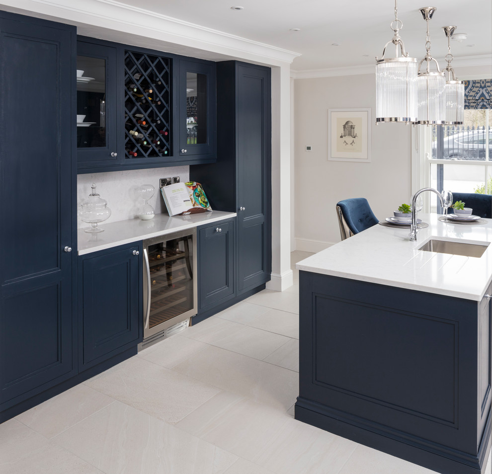 Inspiration for a transitional kitchen in Dublin with an integrated sink, shaker cabinets, blue cabinets, quartzite benchtops, mirror splashback, stainless steel appliances and with island.